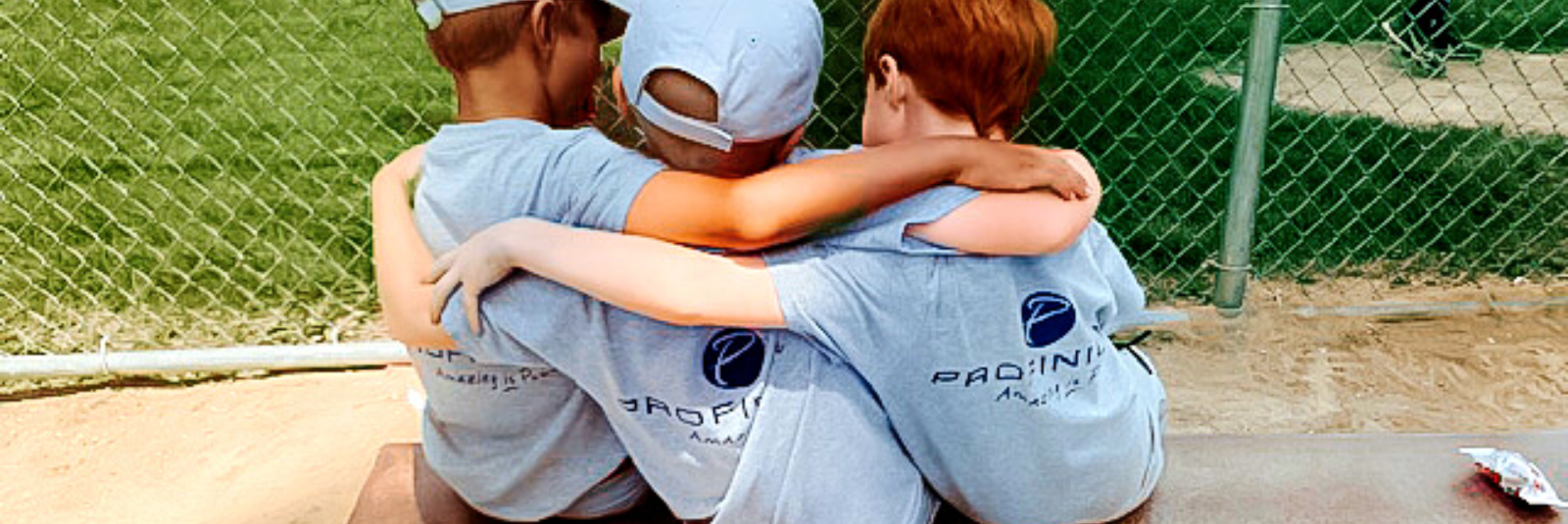 kids hugging wearing profinium t-shirts