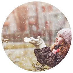 Girl catching snowflakes