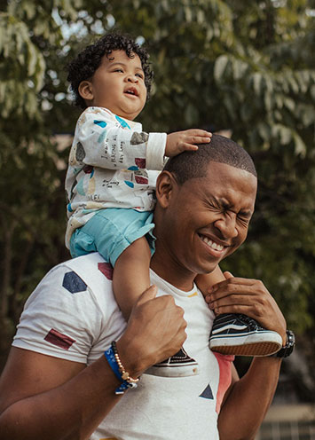 son on father's shoulders