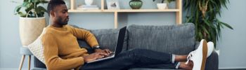 GUy on couch with computer