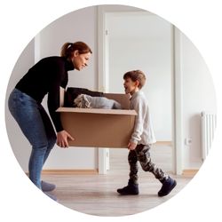 mother and son moving a large box