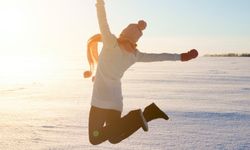 a person outdoors jumping for joy