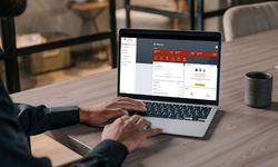 a person using profinium online banking on their laptop