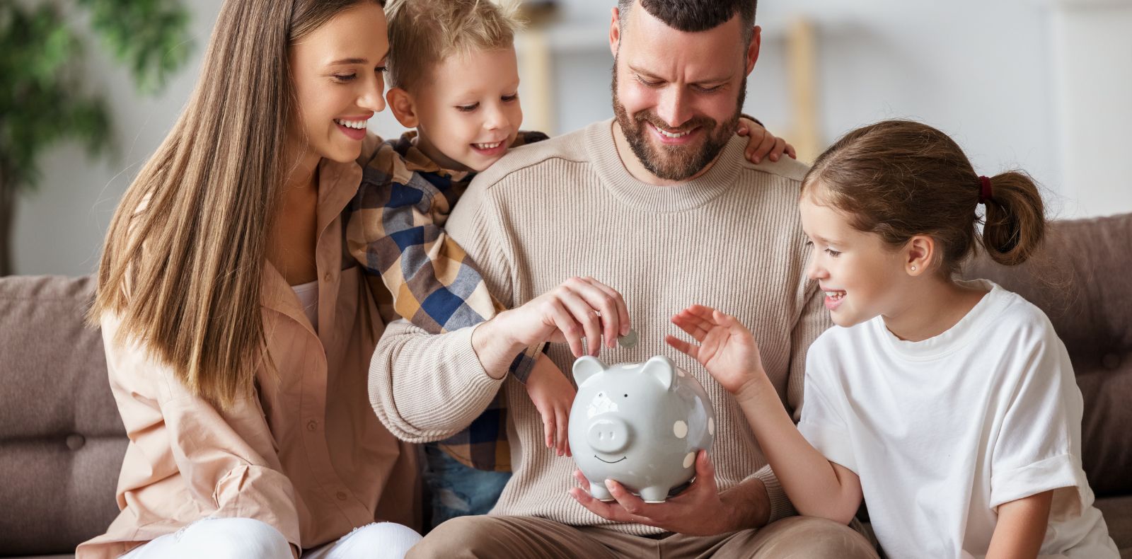 a family putting coins in a piggy bank