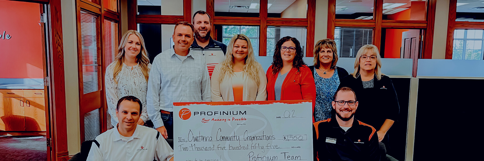 Owatonna Branch team holding a large sized check