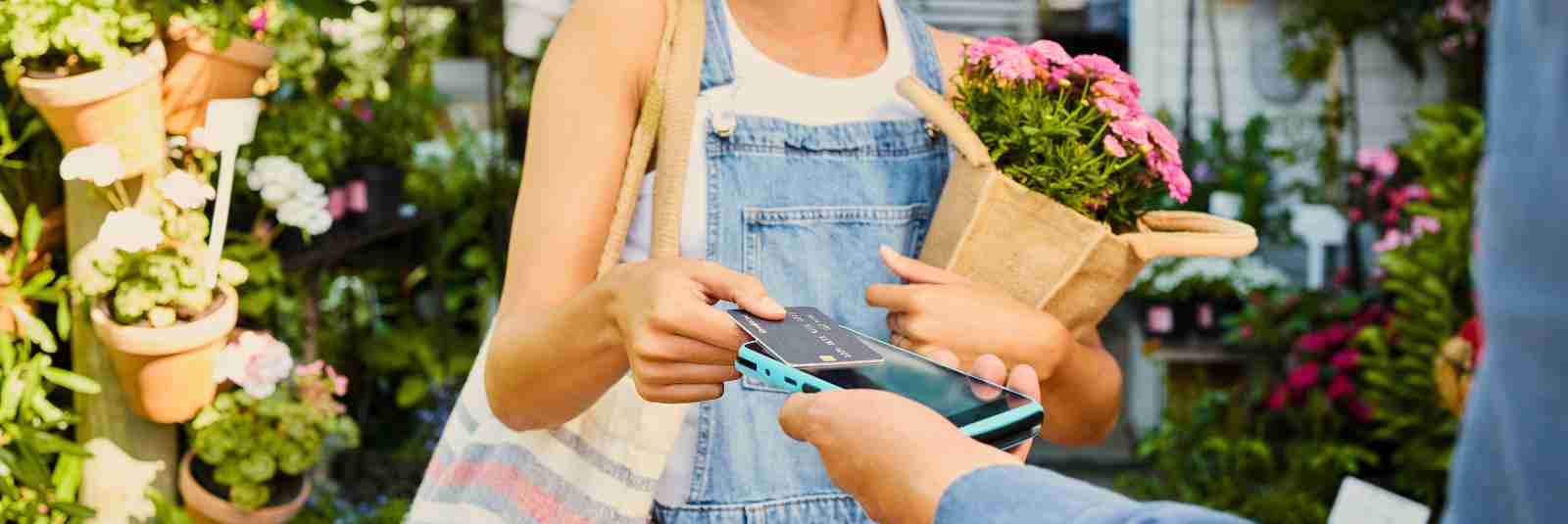 Woman uses her Profinium Credit Card to buy flowers at a local shop in southern Minnesota.
