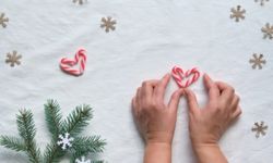 hands preparing heart candy canes