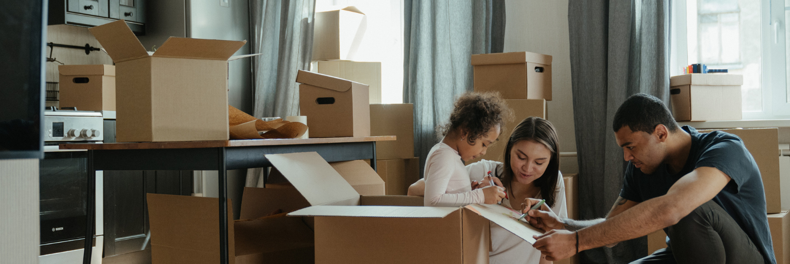 a family unpacking boxes in their new home