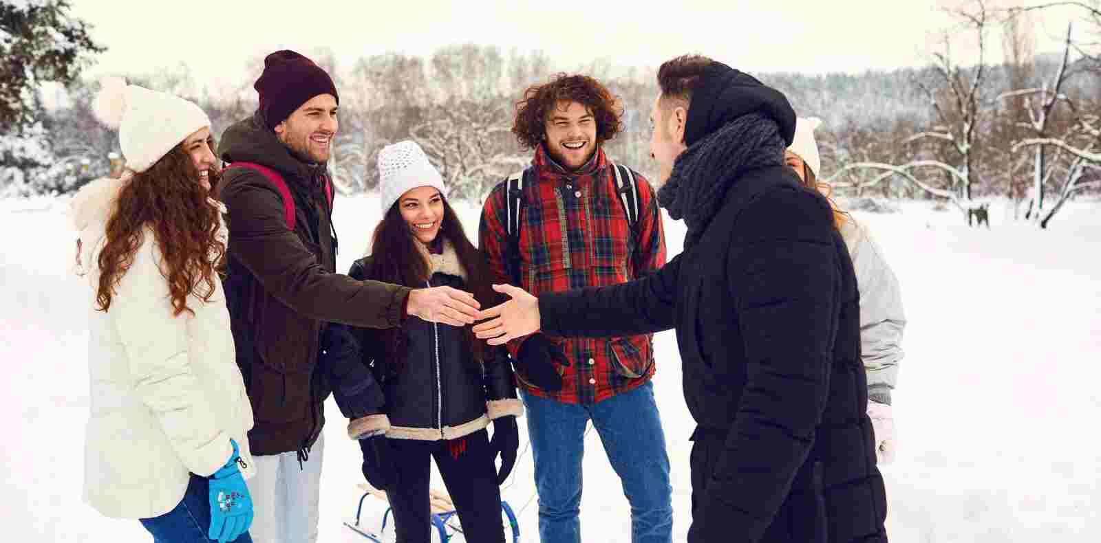 people handshaking outside winter