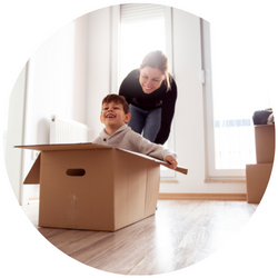 a woman playing with her son in a box
