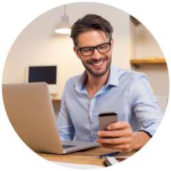 man looking at his phone and computer