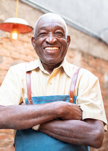 man smiling with his arms crfossed