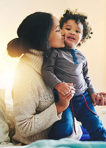 mom kissing son on cheek 