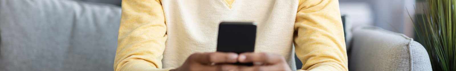 man looking at phone on couch