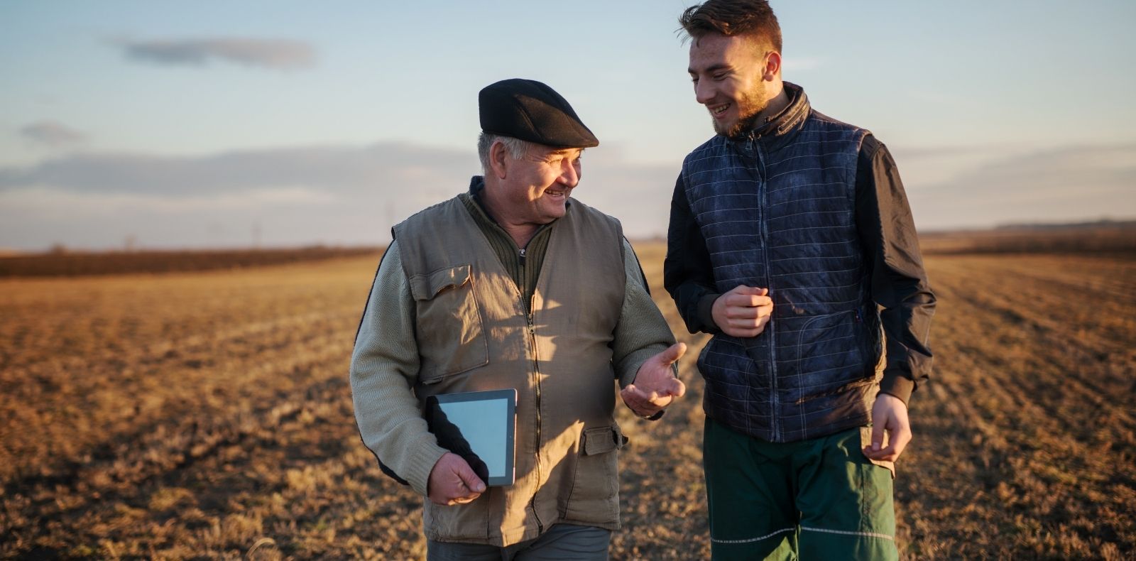 Two men standing in a field
